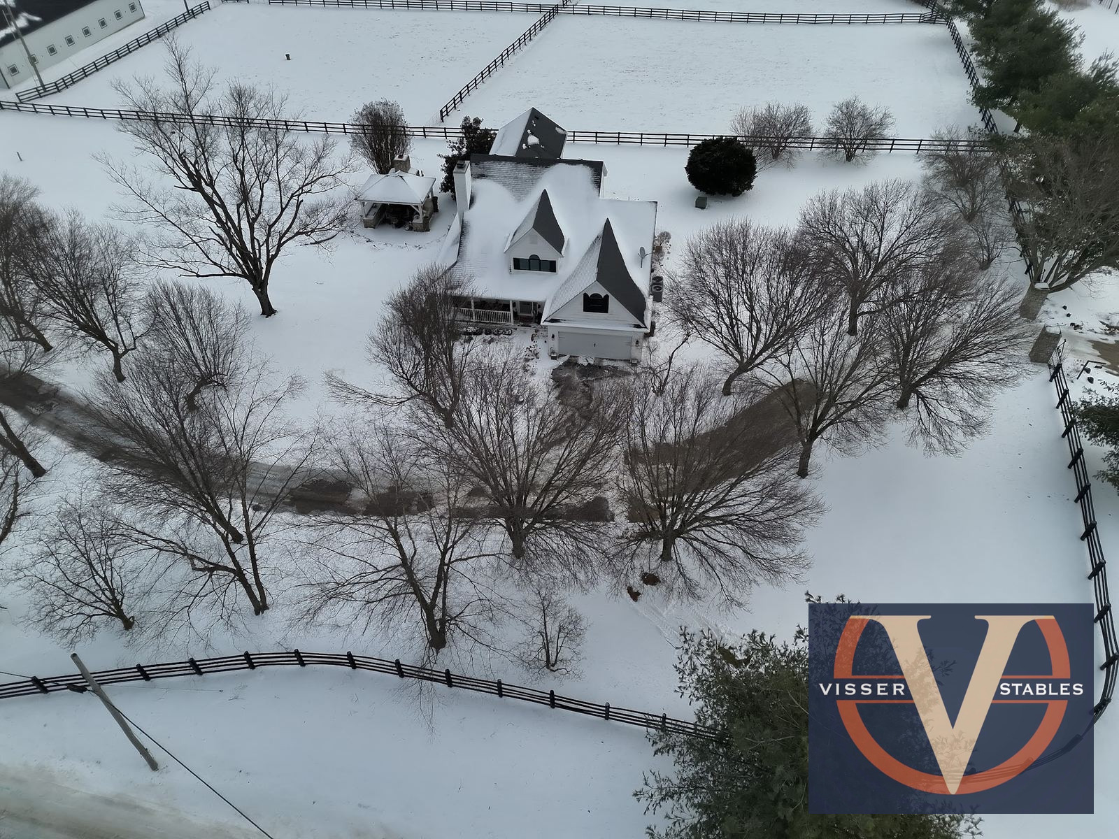 Country estate with fenced pastures, with Visser Stables watermark