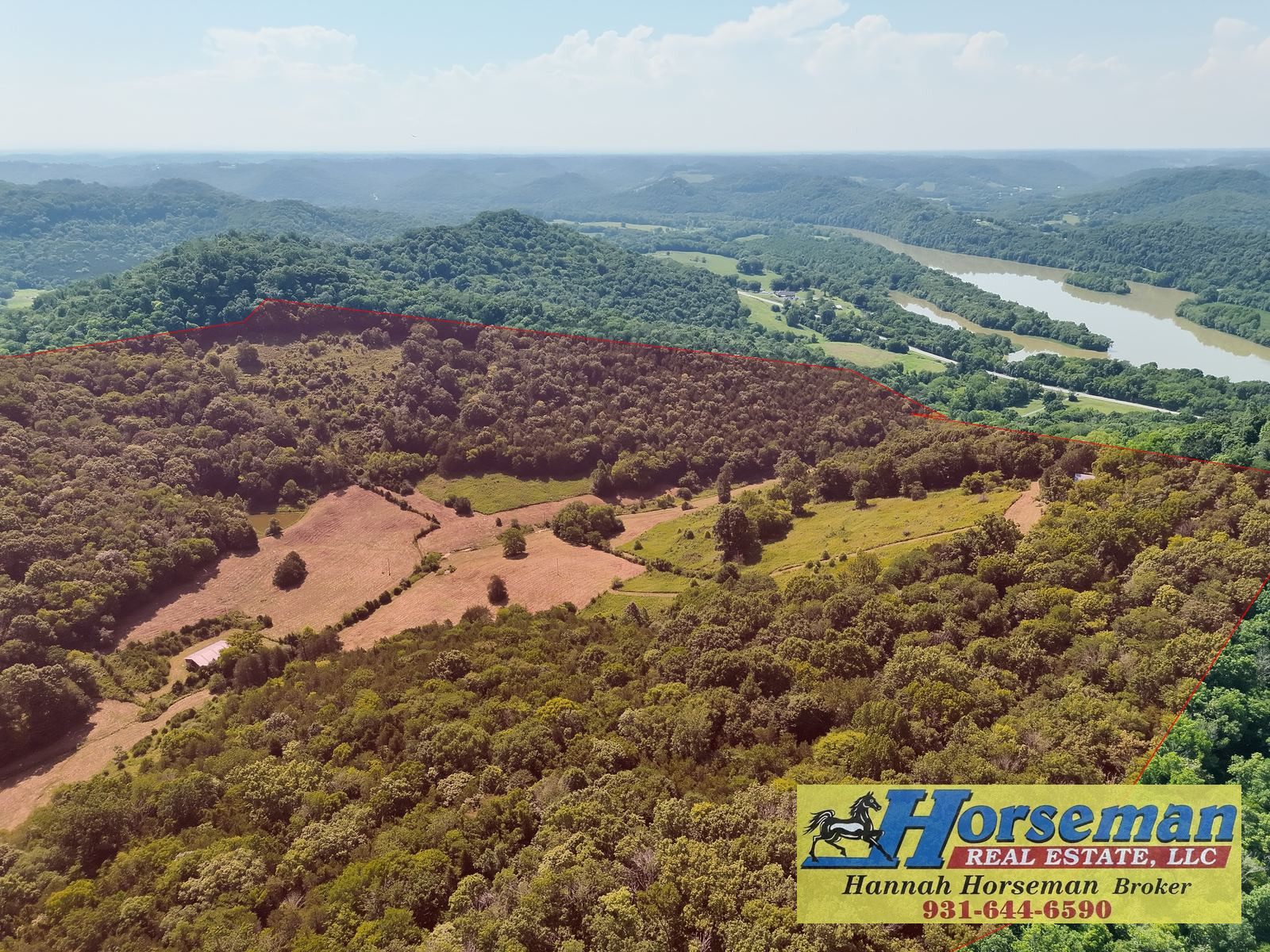 Pastures and river seen from above, with Horseman Real Estate watermark